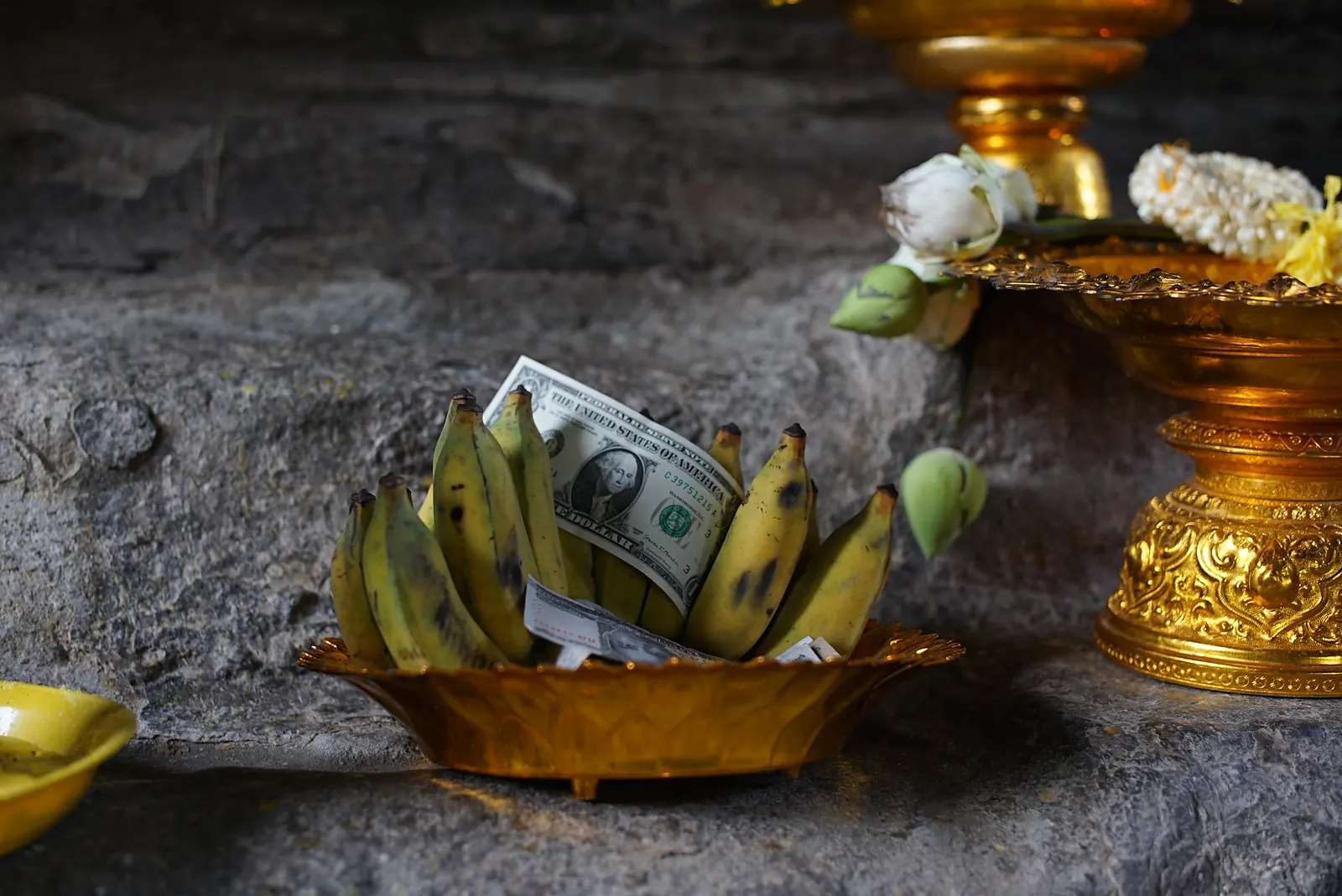 Bananas and an offering in a golden bowl at a temple