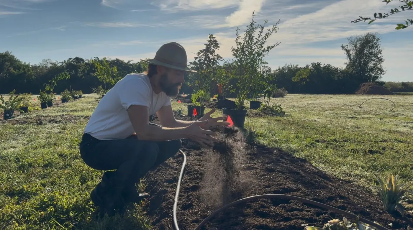Matthew Nadu reading the soil on a Sarasota planting row